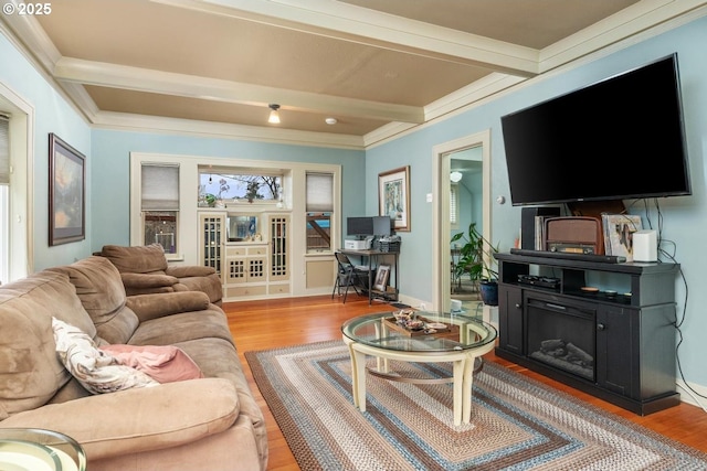 living room featuring light hardwood / wood-style floors, crown molding, and beam ceiling