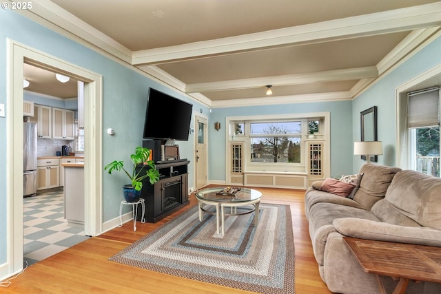 living room featuring light wood-type flooring, ornamental molding, and beamed ceiling