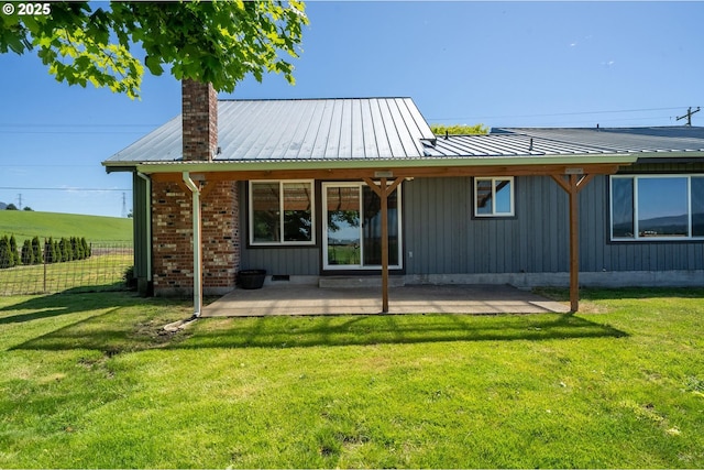 1770 Mccormick Loop Rd, Tillamook, OR 97141 - rear view of house featuring a patio area, a chimney, and metal roof