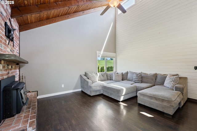 1770 Mccormick Loop Rd, Tillamook, OR 97141 - living room with ceiling fan, high vaulted ceiling, a wood stove, baseboards, and wooden ceiling with exposed beams