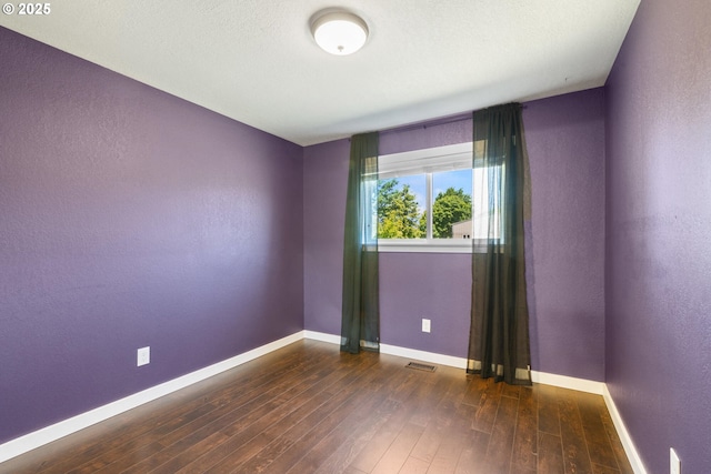 1770 Mccormick Loop Rd, Tillamook, OR 97141 - empty room featuring hardwood / wood-style flooring, baseboards, and a textured wall