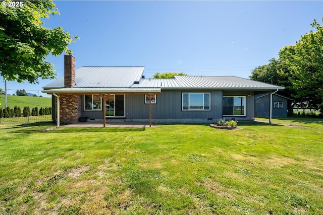 1770 Mccormick Loop Rd, Tillamook, OR 97141 - back of property featuring a chimney, a patio, a lawn, and metal roof