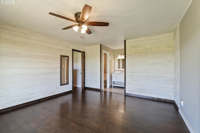1770 Mccormick Loop Rd, Tillamook, OR 97141 - empty room featuring a ceiling fan, wood finished floors, wood walls, and baseboards