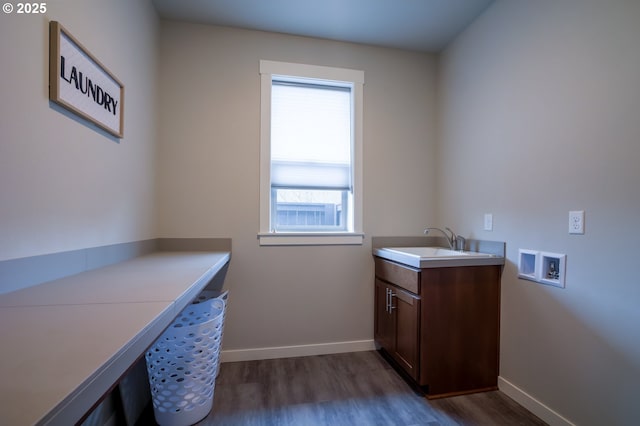 clothes washing area featuring hookup for a washing machine, dark wood-type flooring, and baseboards