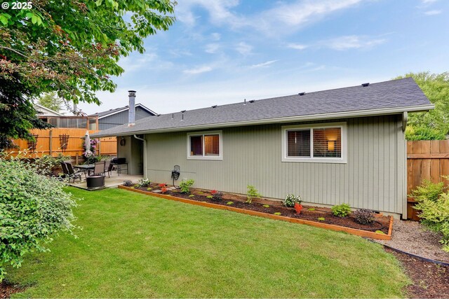 back of property featuring a patio and roof with shingles