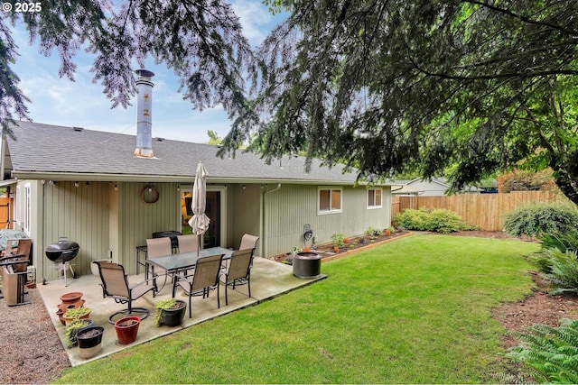 back of property featuring a patio and a shingled roof