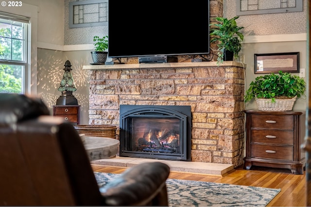 487 Arkansas Ave, Vernonia, OR 97064 - living room with a stone fireplace, wood finished floors, and wallpapered walls