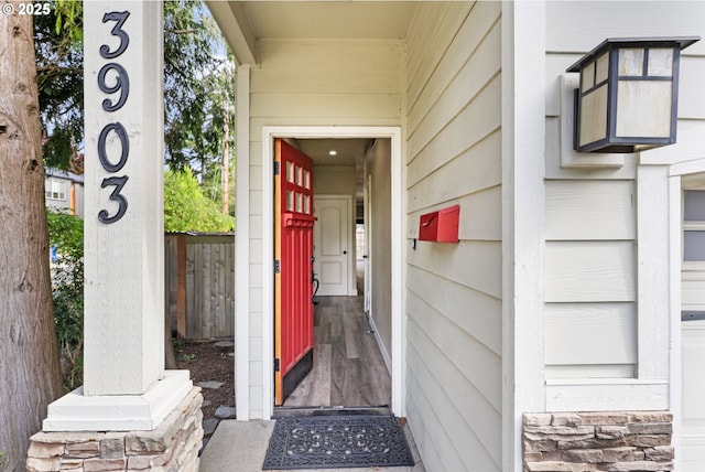 entrance to property featuring fence