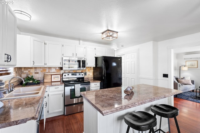 kitchen featuring white cabinetry, stainless steel appliances, dark wood-type flooring, and sink