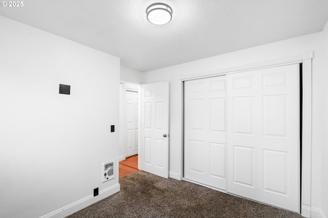 unfurnished bedroom featuring carpet and a closet