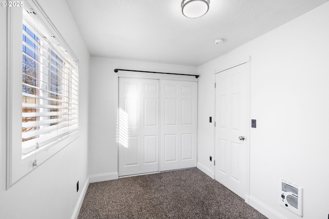 unfurnished bedroom with carpet floors and a closet