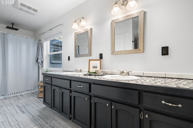 bathroom with vanity and curtained shower