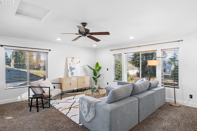 carpeted living room with ceiling fan