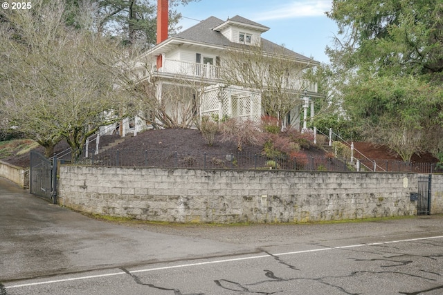 american foursquare style home featuring stairs and fence