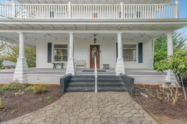 property entrance with a porch and a balcony