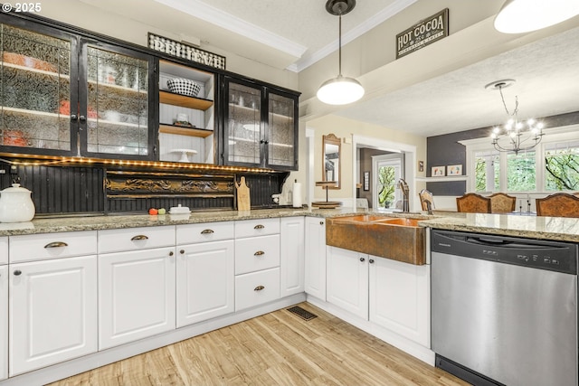 kitchen with a sink, light wood-style floors, ornamental molding, dishwasher, and pendant lighting