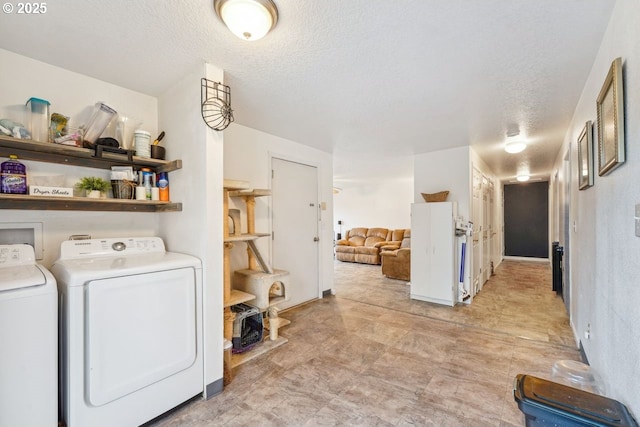 laundry area featuring laundry area, separate washer and dryer, and a textured ceiling