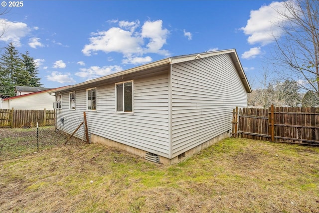 view of property exterior featuring crawl space, a lawn, and fence