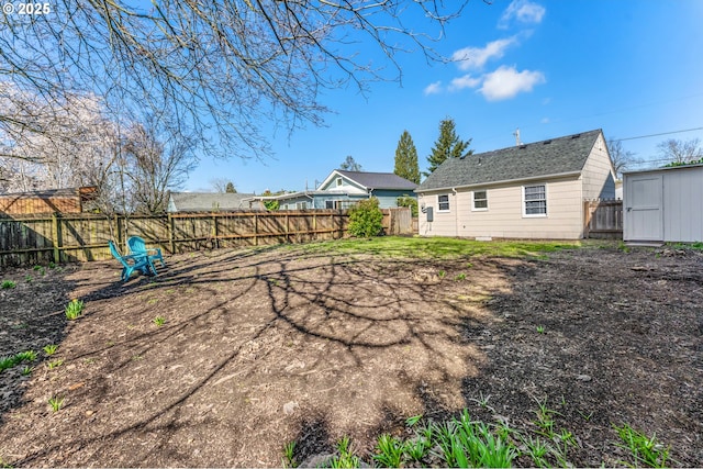 back of house with a storage unit, an outdoor structure, and a fenced backyard