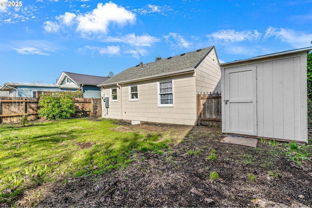 rear view of property with a storage shed, a fenced backyard, a lawn, and an outdoor structure