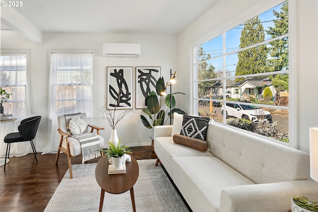 interior space with baseboards, an AC wall unit, and wood finished floors