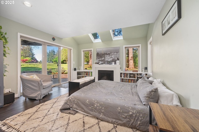 22405 NE 167th Ave, Battle Ground, WA 98604 - bedroom featuring access to exterior, a skylight, wood finished floors, a fireplace, and recessed lighting