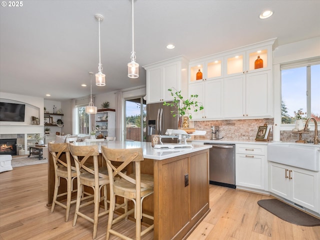 kitchen featuring a kitchen island, white cabinets, and appliances with stainless steel finishes