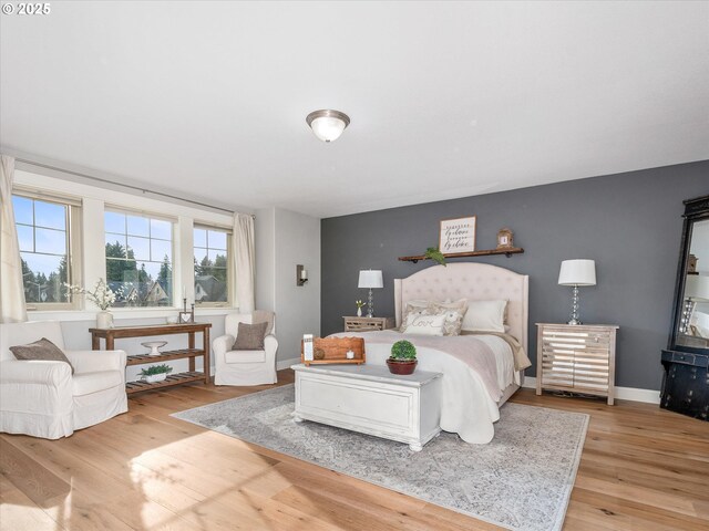 living room featuring a tiled fireplace and hardwood / wood-style floors