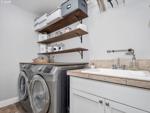 laundry room featuring sink, cabinets, and washing machine and clothes dryer