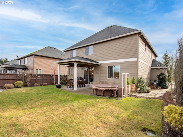 rear view of house with a yard and a patio area