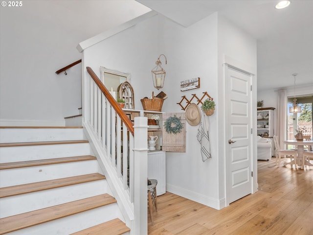 staircase with wood-type flooring