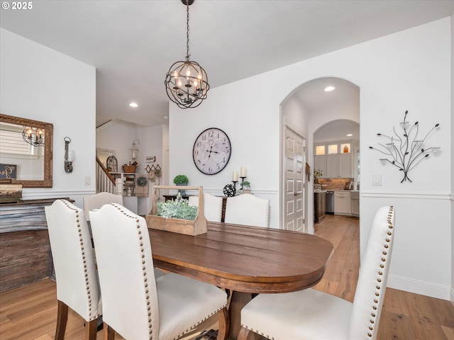 dining space featuring a notable chandelier and light hardwood / wood-style floors