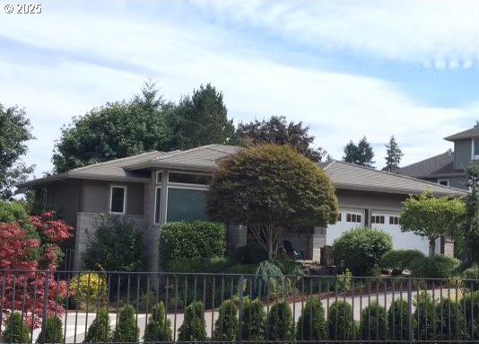 view of front of property with fence and a garage