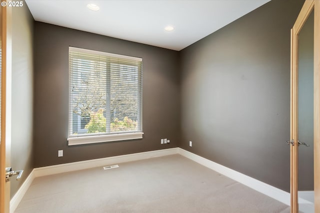 carpeted spare room featuring recessed lighting and baseboards