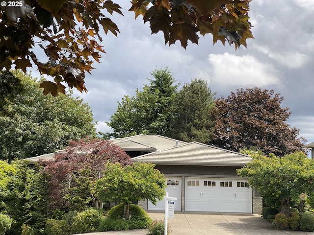22040 Shannon Pl, West Linn, OR 97068 - view of home's exterior with driveway, a garage, a tile roof, and brick siding