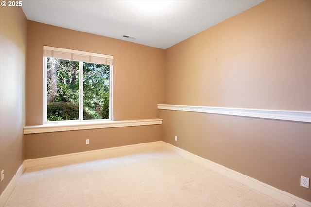 unfurnished room featuring carpet floors and baseboards