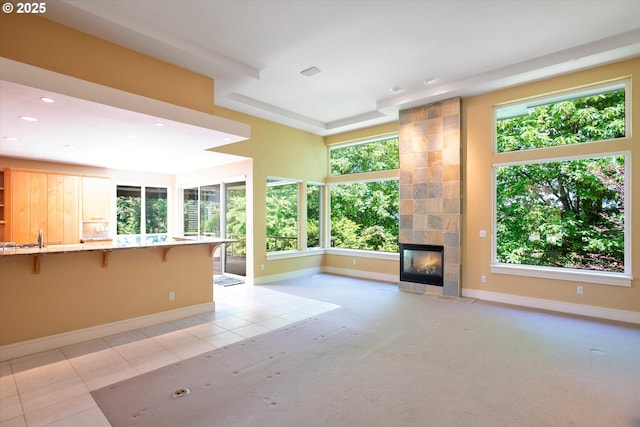 unfurnished living room featuring a fireplace, baseboards, recessed lighting, and light tile patterned floors