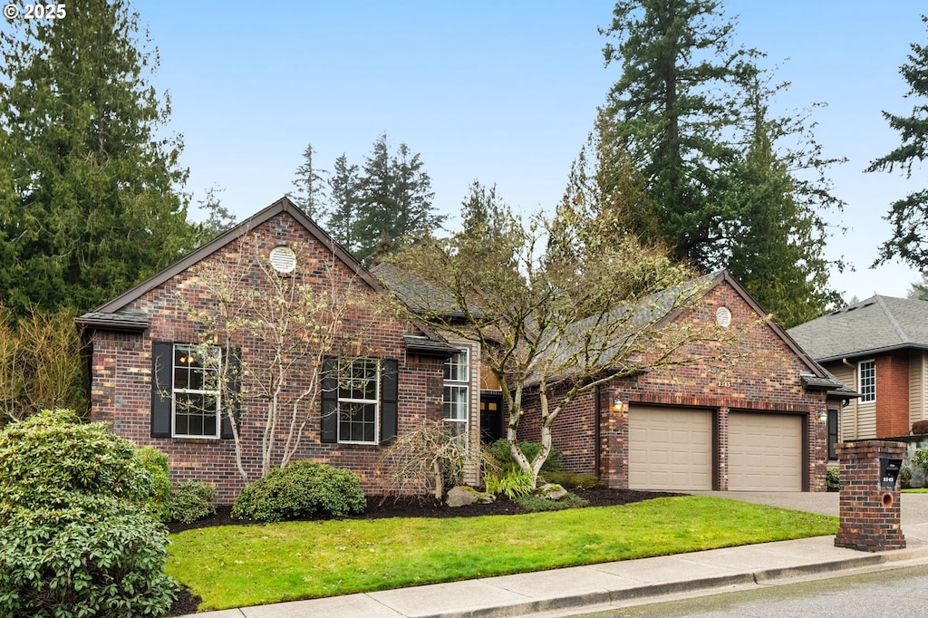 view of property with a garage and a front yard