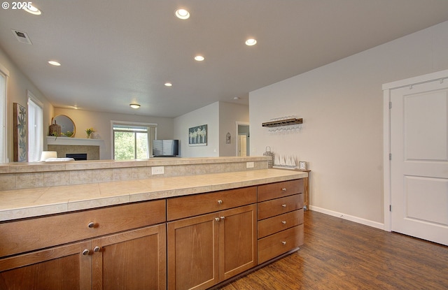 530 N Helens View Dr, Ridgefield, WA 98642 - kitchen with brown cabinetry, dark wood finished floors, light countertops, baseboards, and recessed lighting