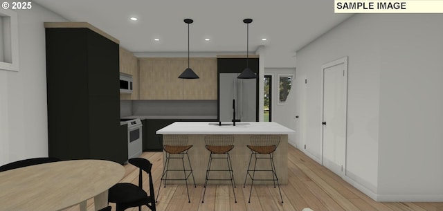 kitchen with a kitchen bar, light wood-type flooring, white appliances, decorative light fixtures, and a center island