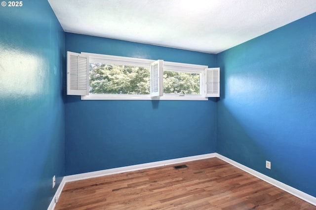 3185 Granada Way, Salem, OR 97302 - unfurnished room with plenty of natural light, wood finished floors, and baseboards