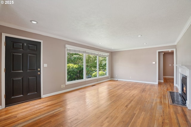 3185 Granada Way, Salem, OR 97302 - unfurnished living room featuring light wood-style flooring, a fireplace with flush hearth, baseboards, crown molding, and recessed lighting