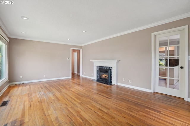 3185 Granada Way, Salem, OR 97302 - unfurnished living room with light wood-style floors, crown molding, a premium fireplace, baseboards, and recessed lighting