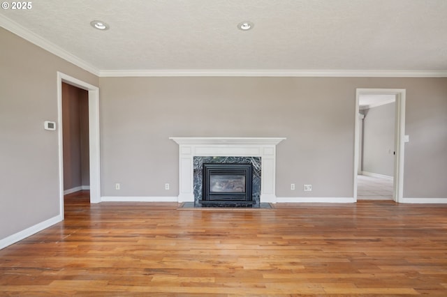 3185 Granada Way, Salem, OR 97302 - unfurnished living room with ornamental molding, light wood-style flooring, baseboards, a premium fireplace, and recessed lighting