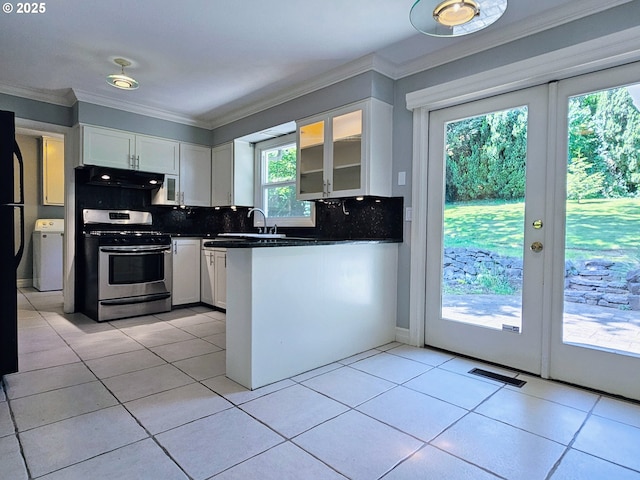 3185 Granada Way, Salem, OR 97302 - kitchen with stainless steel range with gas stovetop, washer / clothes dryer, ornamental molding, backsplash, and white cabinets