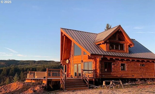 55778 SW Scoggins Valley Rd, Gaston, OR 97119 - living area with dark wood finished floors, french doors, wooden ceiling with exposed beams, a chandelier, and high vaulted ceiling