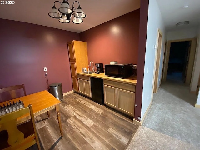 55778 SW Scoggins Valley Rd, Gaston, OR 97119 - kitchen with black microwave, a sink, a chandelier, light countertops, and wood finished floors