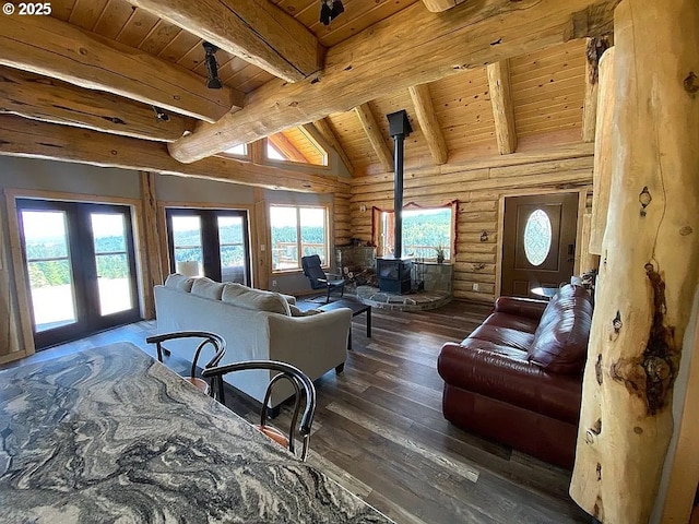 55778 SW Scoggins Valley Rd, Gaston, OR 97119 - bedroom featuring wooden ceiling with exposed beams, a wood stove, wood-type flooring, french doors, and log walls