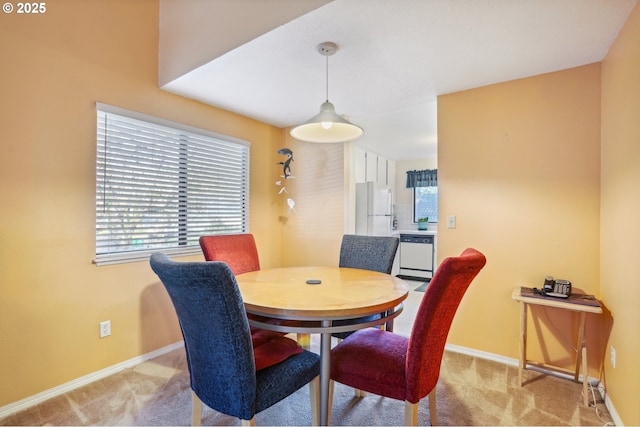 dining space with light colored carpet