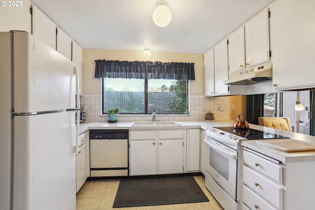 kitchen with tasteful backsplash, white cabinetry, sink, kitchen peninsula, and white appliances